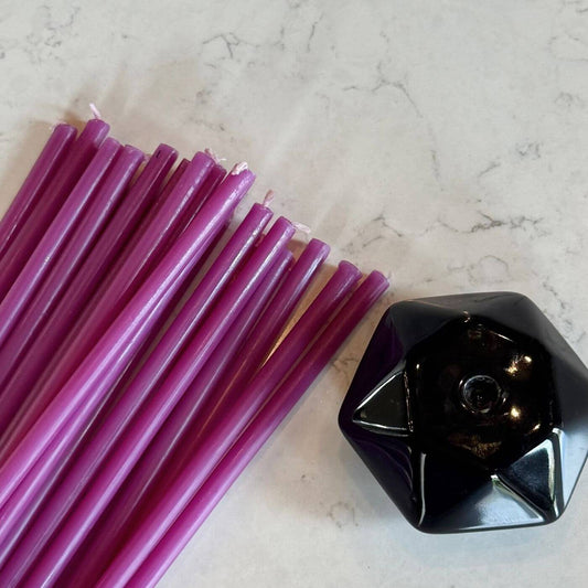 Purple thin tapers with a black holder