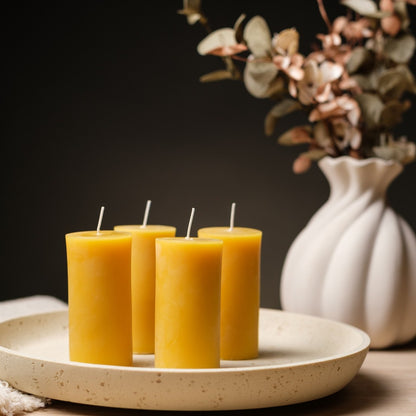 Natural beeswax pillar candles 2 by 4 inch, four candles on a round plate