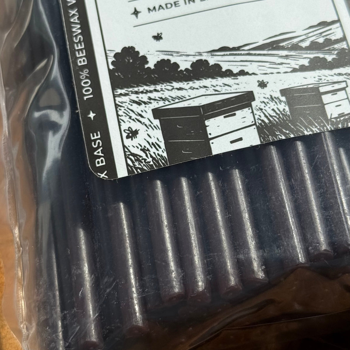 Black beeswax taper candles 6.5″, packaging label closeup