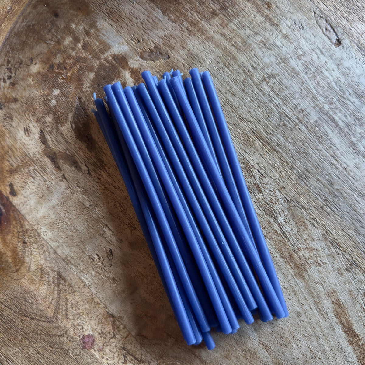Blue beeswax taper candles 6.5″, bundle on wood slice