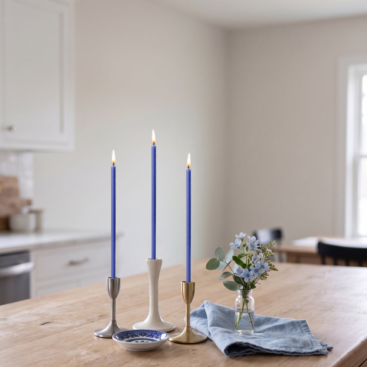Blue beeswax taper candles 6.5″, lit in candlesticks interior