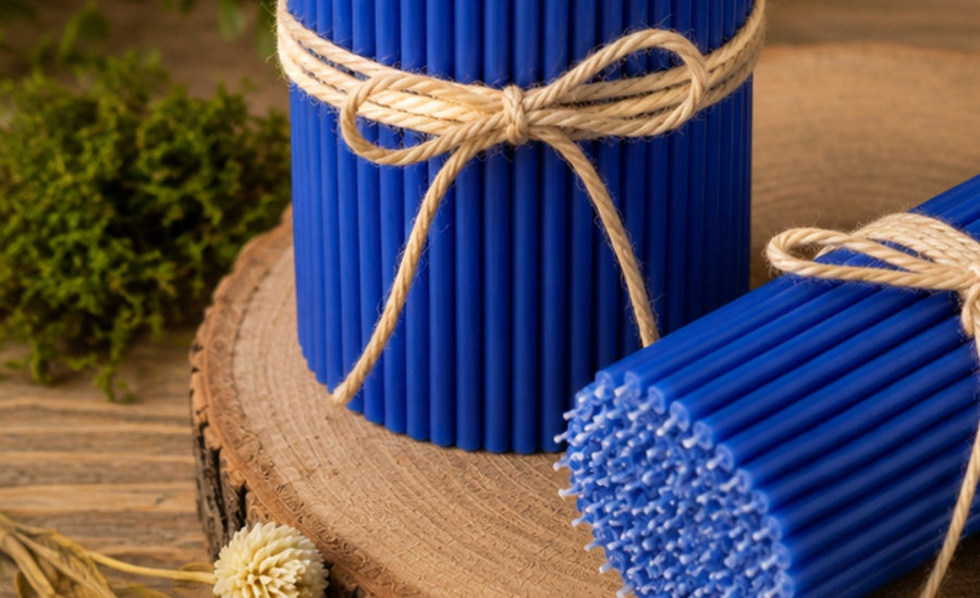 Blue thin beeswax taper candles on a wood slice, Closterra