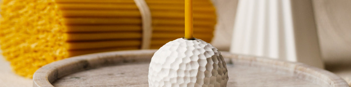 Closterra beeswax candle in a honeycomb holder
