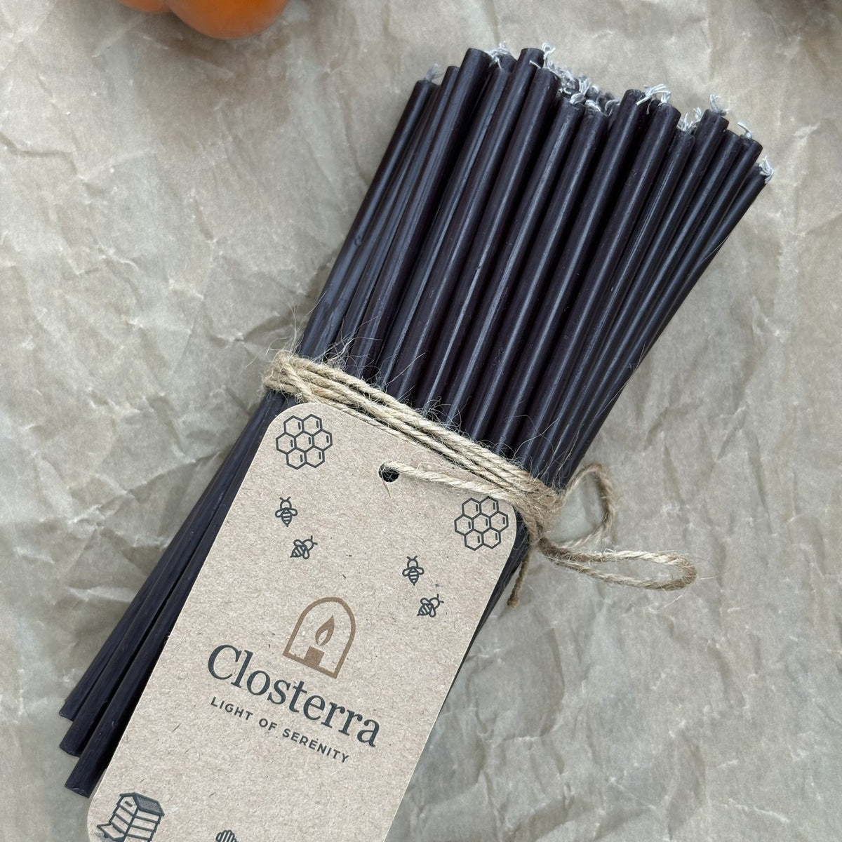 Black beeswax taper candles 6.3″, bundle of 100 with Closterra tag on kraft paper