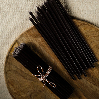 Black beeswax taper candles 6.3″, bundle tied with twine on a wooden tray