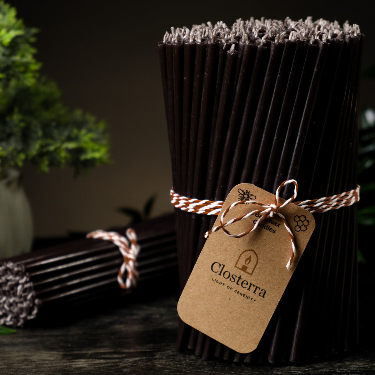 Black beeswax taper candles 7.3″, bundle with a Closterra tag, close-up