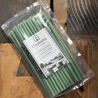 Green beeswax taper candles 7.3″, in Closterra packaging on rustic wood