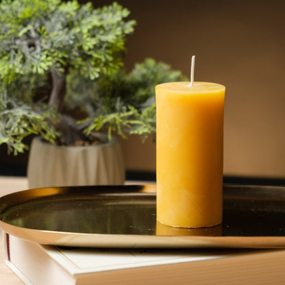 Natural beeswax pillar candle 2 by 4 inch, single candle on a gold tray