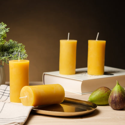 Natural beeswax pillar candle styled with fresh figs as a rustic centerpiece