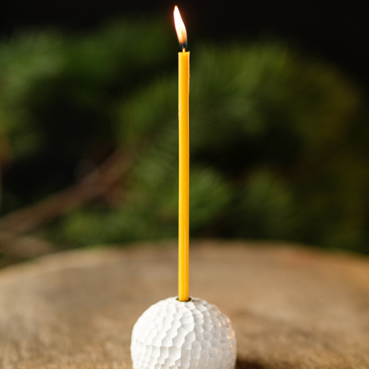 Natural yellow beeswax taper candles 10.4″, single lit taper in a white holder