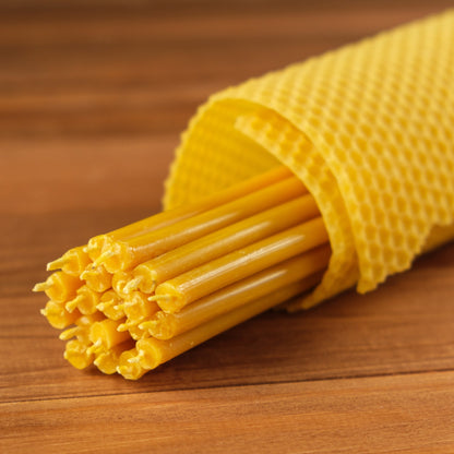 Natural yellow beeswax taper candles 7.3″, bundle wrapped in a honeycomb sheet, close-up