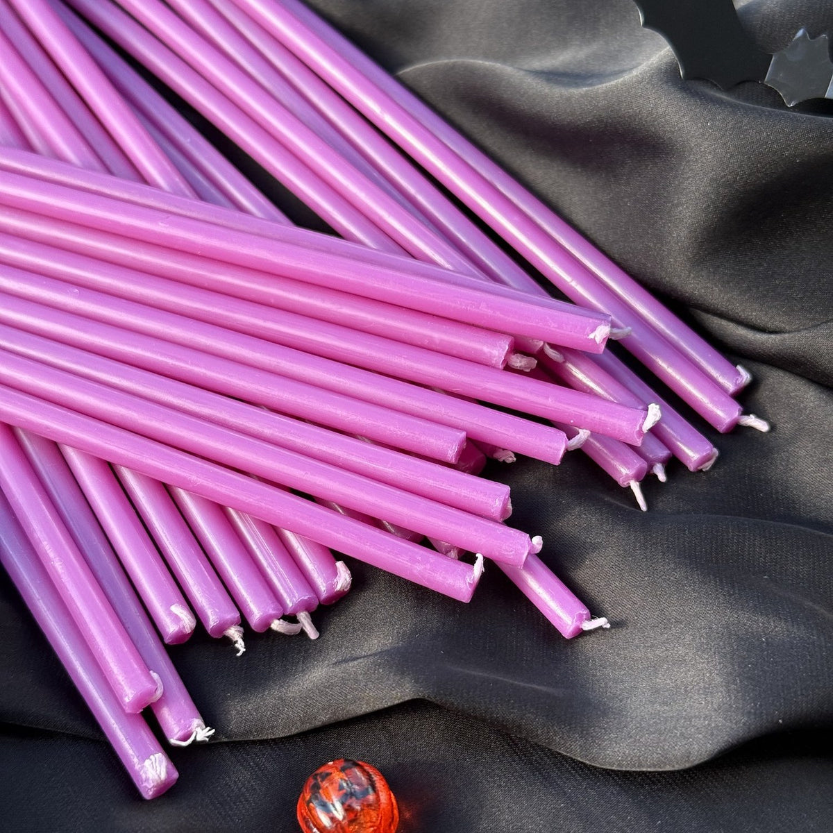 Purple beeswax taper candles 6.5″, loose tapers on black satin