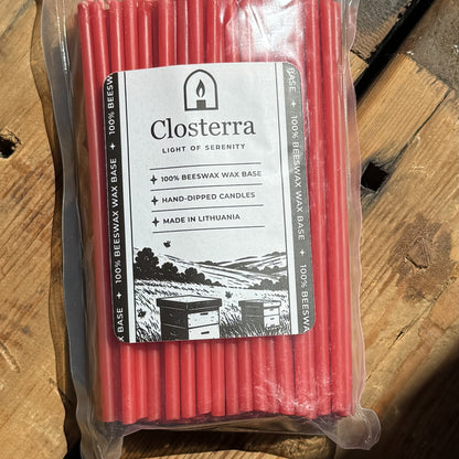 Red beeswax taper candles 6.3″, in Closterra packaging on rustic wood