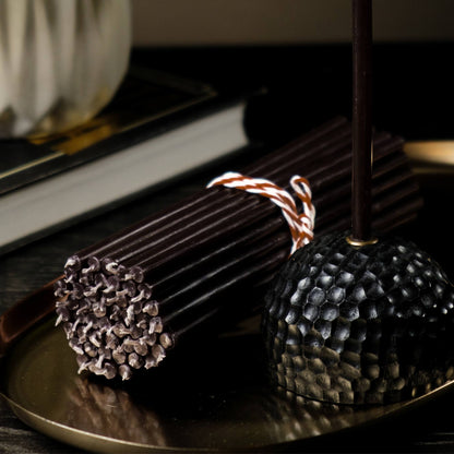Closterra thin black beeswax taper candles, styled on a table