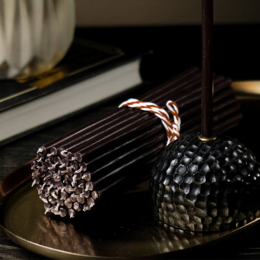 Closterra thin black beeswax taper candles, styled on a table