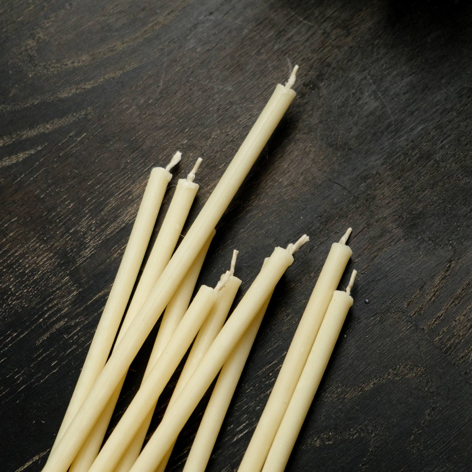 Closterra thin white beeswax taper candles, loose unlit tapers