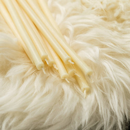 Closterra thin white beeswax taper candles, a close-up of the tapers
