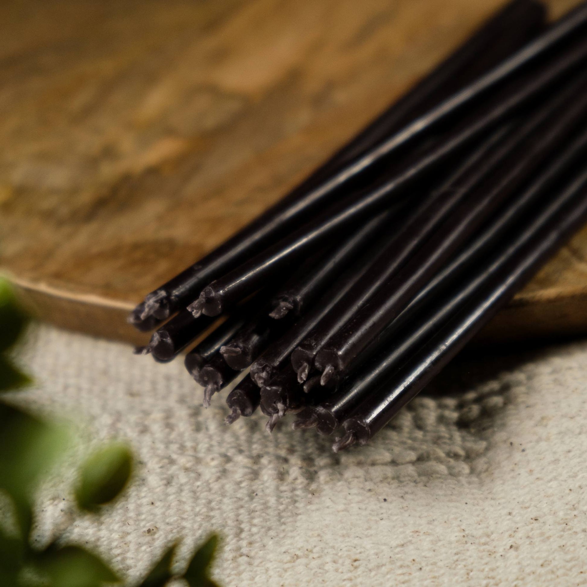 Closterra thin black beeswax taper candles, a close-up of the tapers