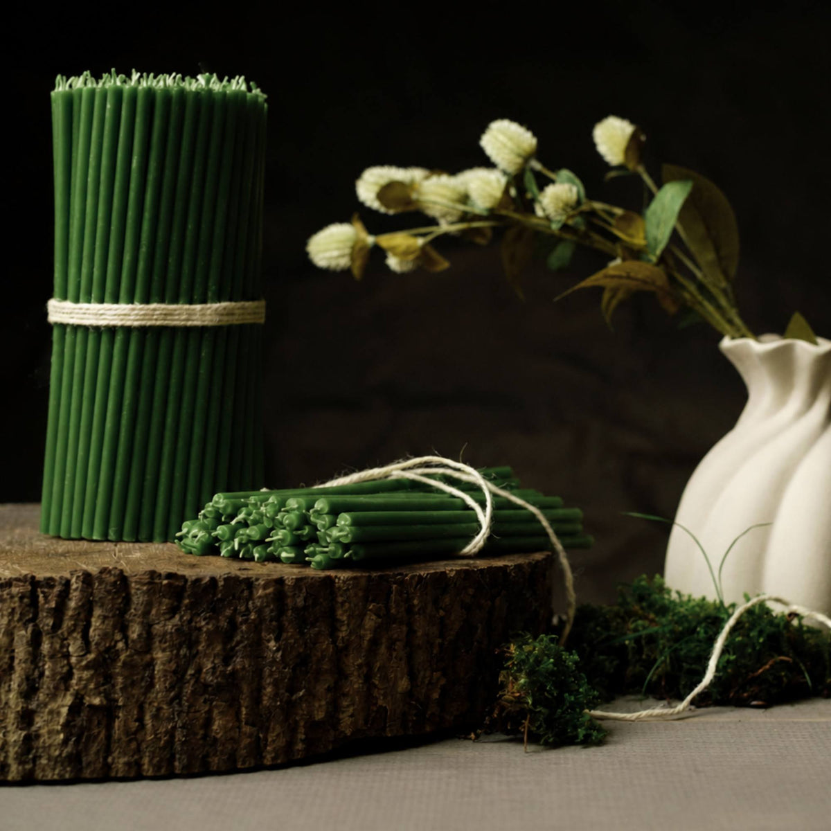 Closterra thin green beeswax taper candles, styled on a table