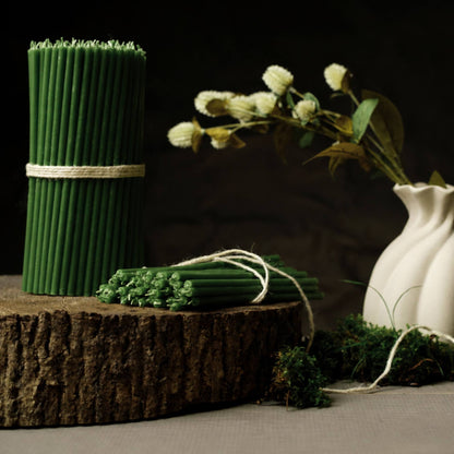 Closterra thin green beeswax taper candles, styled on a table