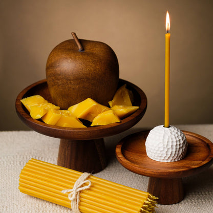 Closterra thin natural yellow beeswax taper candles, lit and styled on a table