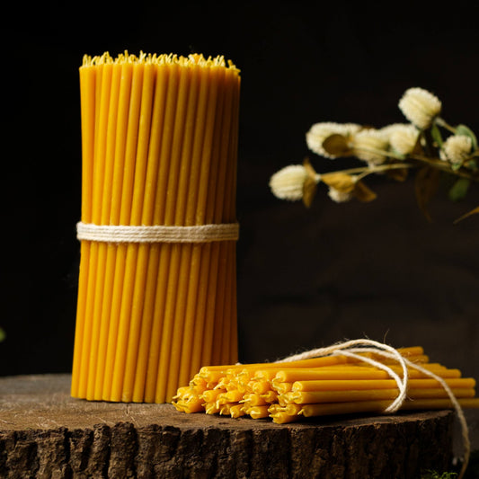 Closterra thin natural yellow beeswax taper candles, styled on a table