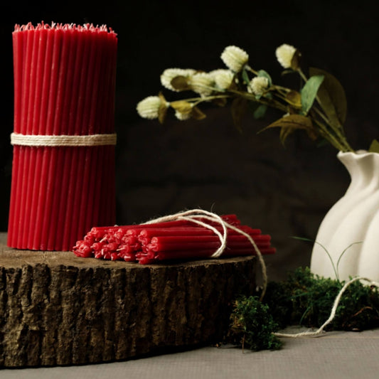 Closterra thin red beeswax taper candles, styled on a table