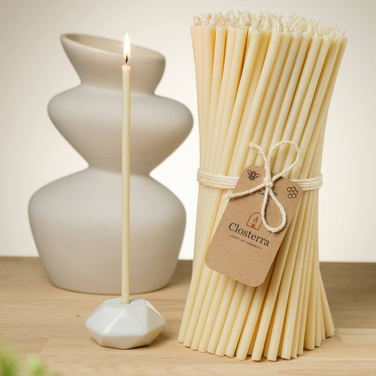 Closterra thin white beeswax taper candles, styled on a table