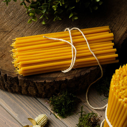 Closterra thin natural yellow beeswax taper candles, a bundle of tapers tied together