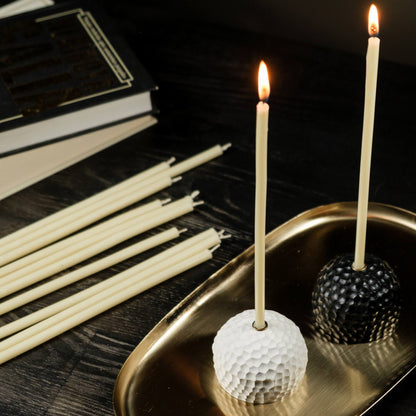 Closterra thin white beeswax taper candles, lit on a tray