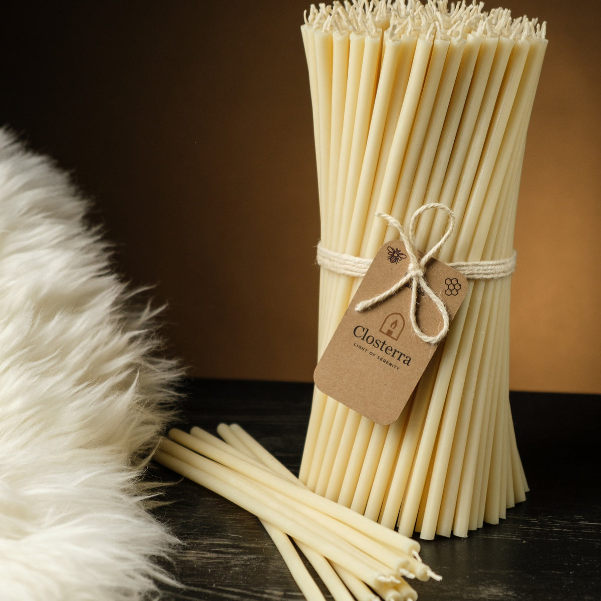 White beeswax taper candles 10.4″, bundle with a Closterra tag beside white faux fur
