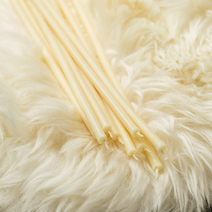 White beeswax taper candles 6.3″, loose tapers on white faux fur
