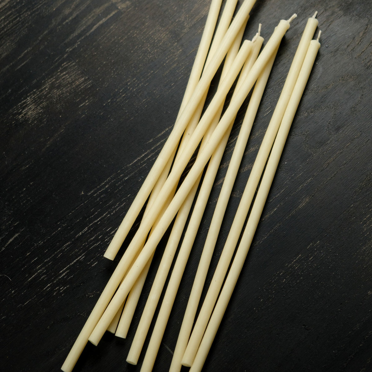 White beeswax taper candles 6.3″, loose tapers on dark wood