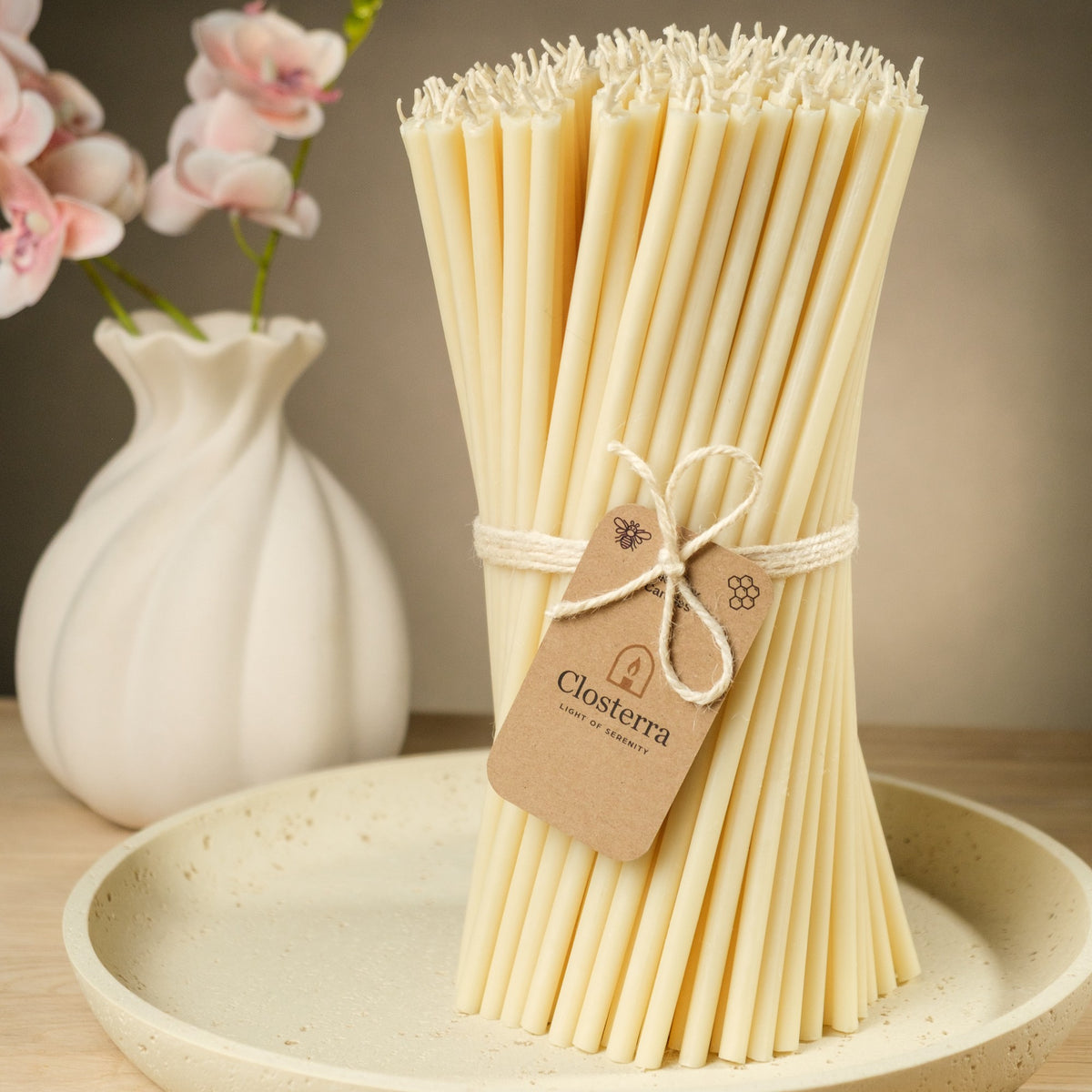 White beeswax taper candles 6.3″, bundle with a Closterra tag beside a white vase
