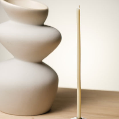 White beeswax taper candles 6.3″, single taper beside a white ceramic vase
