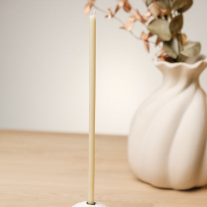 White beeswax taper candles 6.5″, single taper beside a white vase with dried flowers
