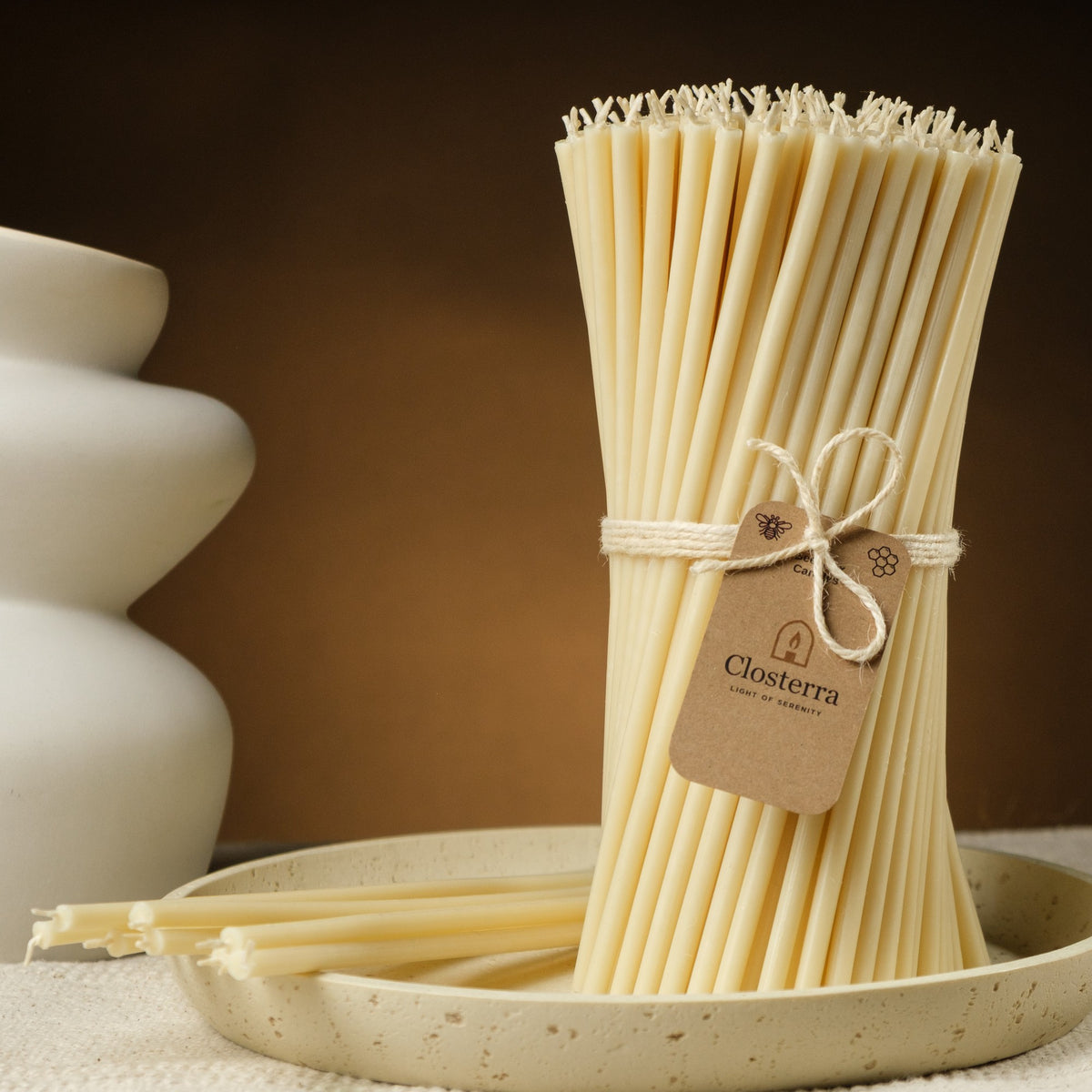 White beeswax taper candles 7.3″, bundle with a Closterra tag beside a white vase