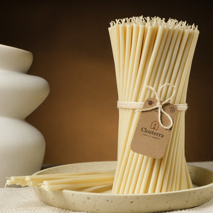 White beeswax taper candles 7.3″, bundle with a Closterra tag beside a white vase
