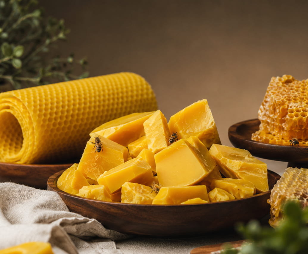 Blocks and cubes of natural beeswax beside honeycomb