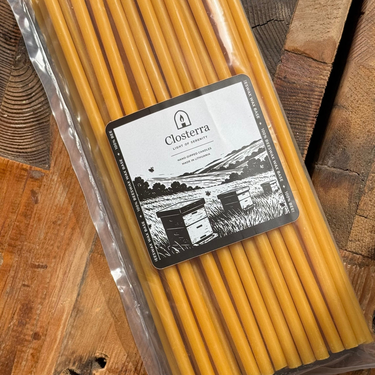 Natural beeswax taper candles 11.6″, pack top down on wood