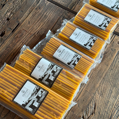 Natural beeswax taper candles 6.5″, packs lined on wood