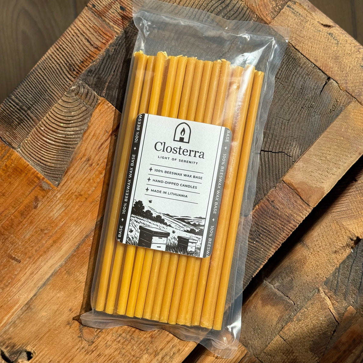 Natural beeswax taper candles 8″, pack top down on wood