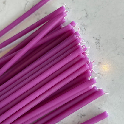 Purple beeswax taper candles 6.5″, closeup wicks on marble