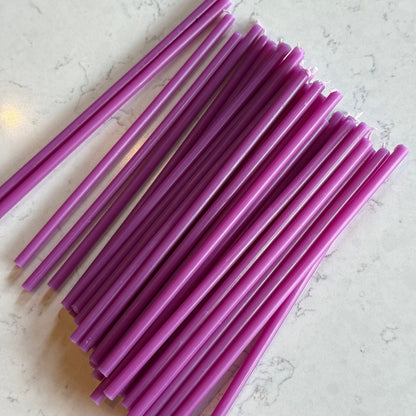 Purple beeswax taper candles 6.5″, fanned out on marble