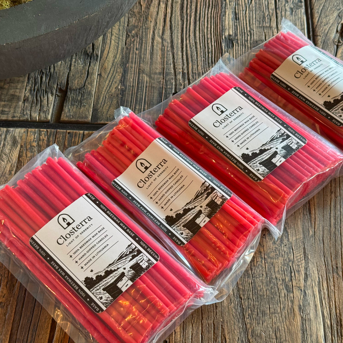 Red beeswax taper candles 6.3″, three packs on wood