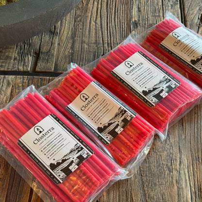 Red beeswax ritual candles 6.3″, three packs on wood