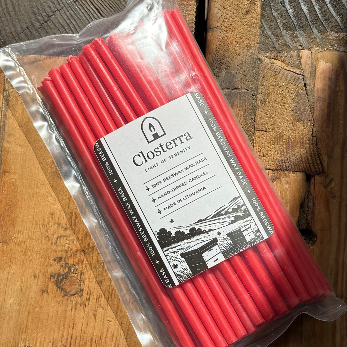 Red beeswax taper candles 8″, single pack on wood